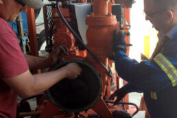 Two of Atlas Dewateing Team doing maintenance on one of their pumps